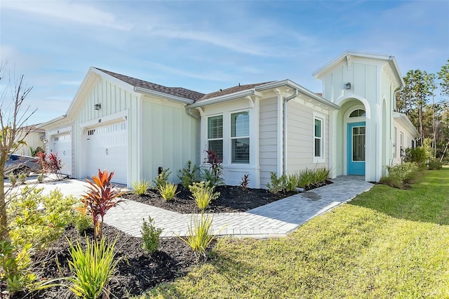 view of front of home with a garage and a front yard