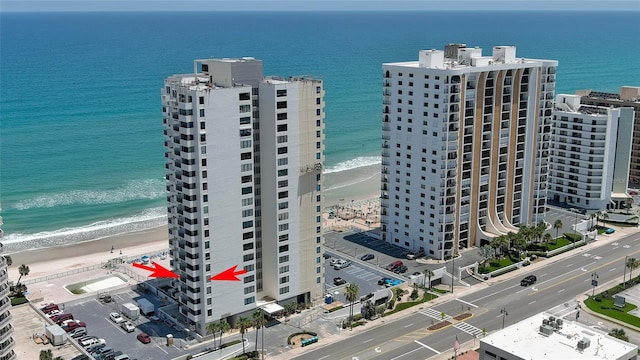 aerial view with a water view and a beach view