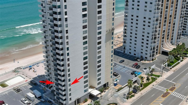 aerial view with a water view and a beach view