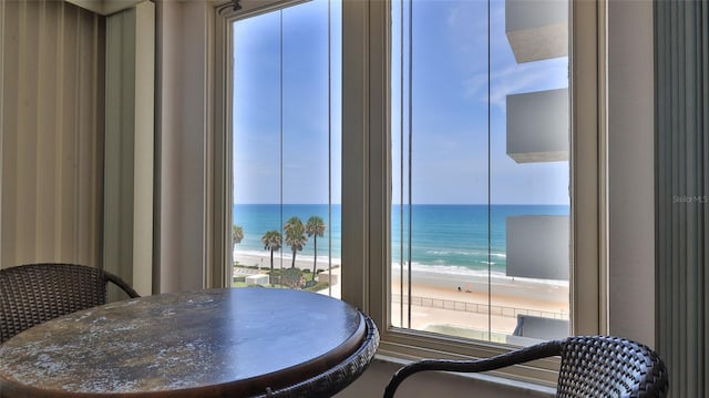 dining area with a water view and a beach view