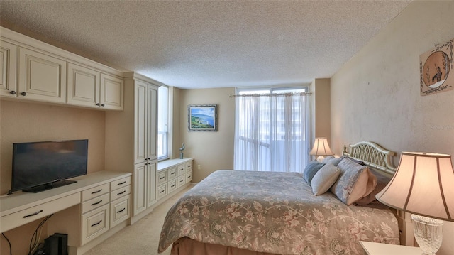 bedroom featuring light carpet, a textured ceiling, and multiple windows