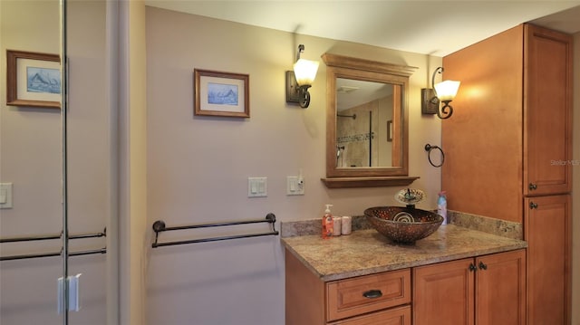 bathroom with vanity and a shower with shower door