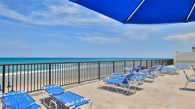 balcony featuring a water view and a beach view