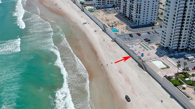 drone / aerial view featuring a water view and a beach view