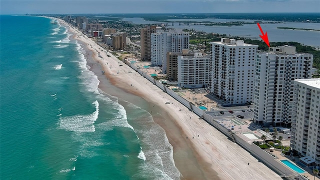 birds eye view of property with a water view and a view of the beach