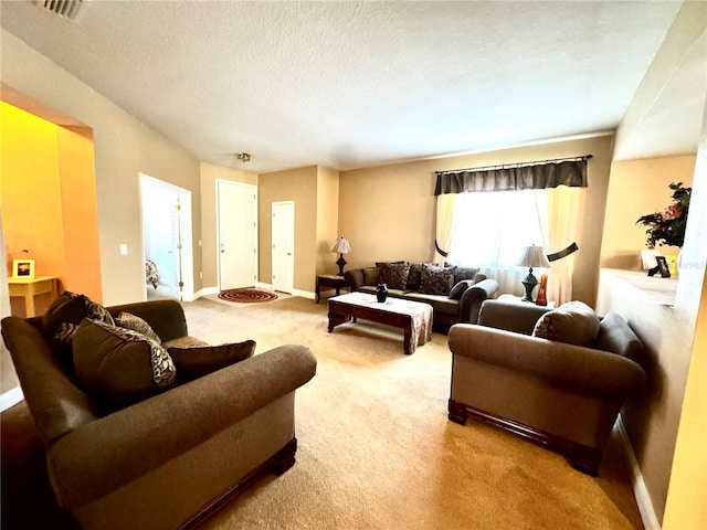 living room featuring carpet and a textured ceiling