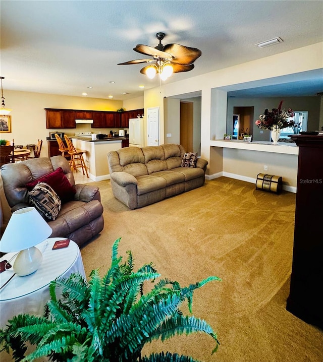 carpeted living room featuring ceiling fan