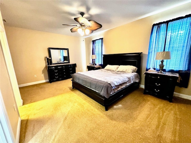 bedroom featuring light carpet and ceiling fan