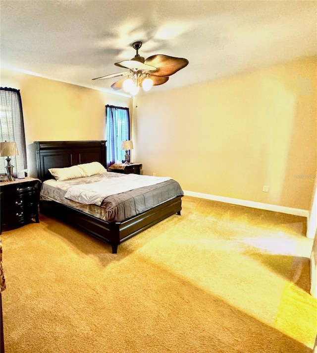 bedroom with ceiling fan, carpet, and multiple windows