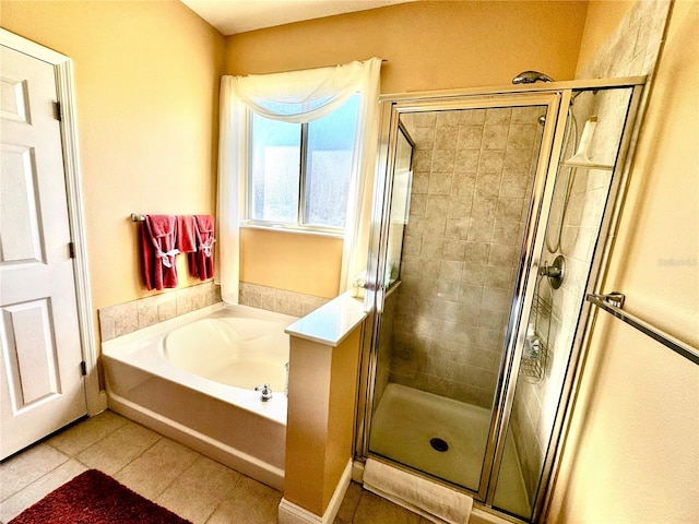 bathroom with separate shower and tub and tile patterned floors