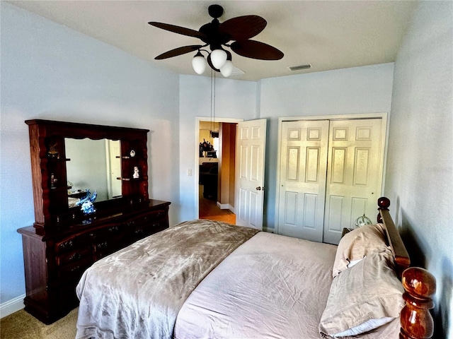 carpeted bedroom with a closet and ceiling fan