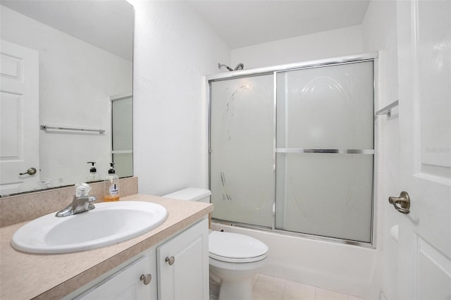 full bathroom with vanity, combined bath / shower with glass door, toilet, and tile patterned floors