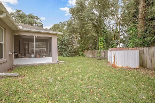 view of yard featuring a sunroom and a storage shed