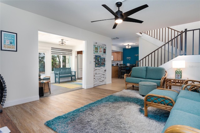 living room featuring light hardwood / wood-style floors and ceiling fan