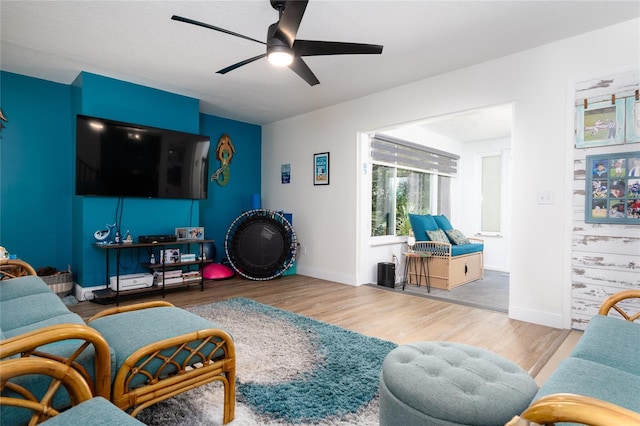 living room featuring ceiling fan and hardwood / wood-style floors