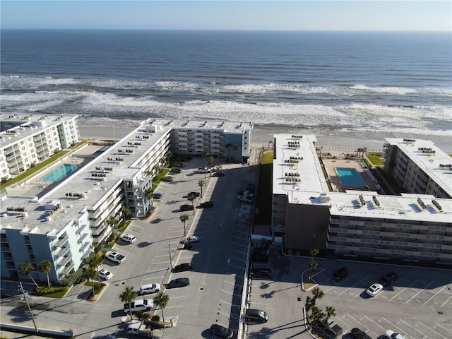 bird's eye view with a water view and a beach view