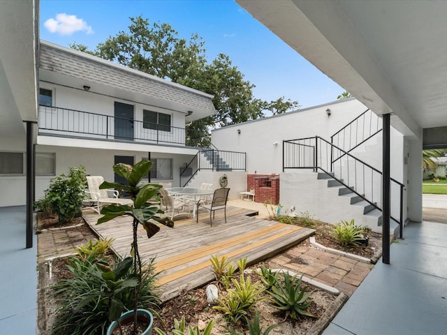 deck with stairs and outdoor dining area