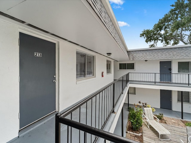 exterior space with stucco siding and a balcony