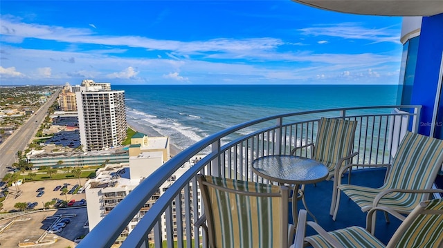 balcony featuring a water view and a beach view