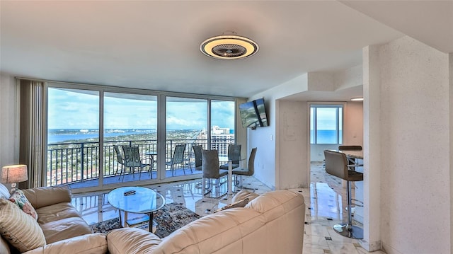 living room featuring a water view and a wall of windows