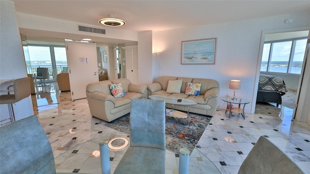 living room with a wealth of natural light and a water view