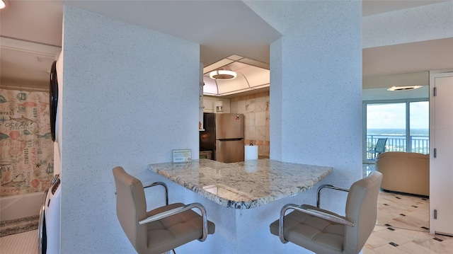 dining space featuring a water view