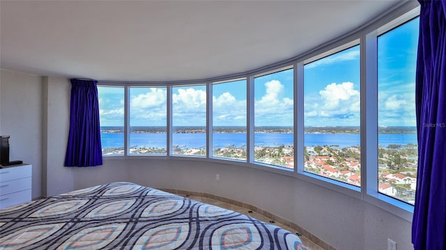 unfurnished bedroom featuring a water view