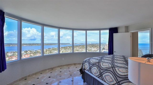 unfurnished bedroom with multiple windows and a water view