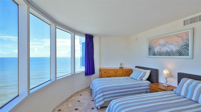 bedroom featuring access to exterior and a water view