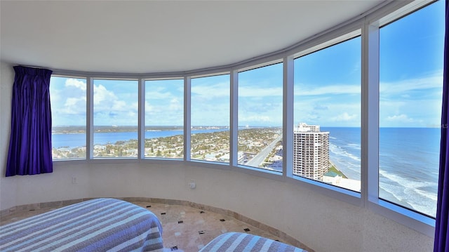 unfurnished bedroom with a beach view and a water view