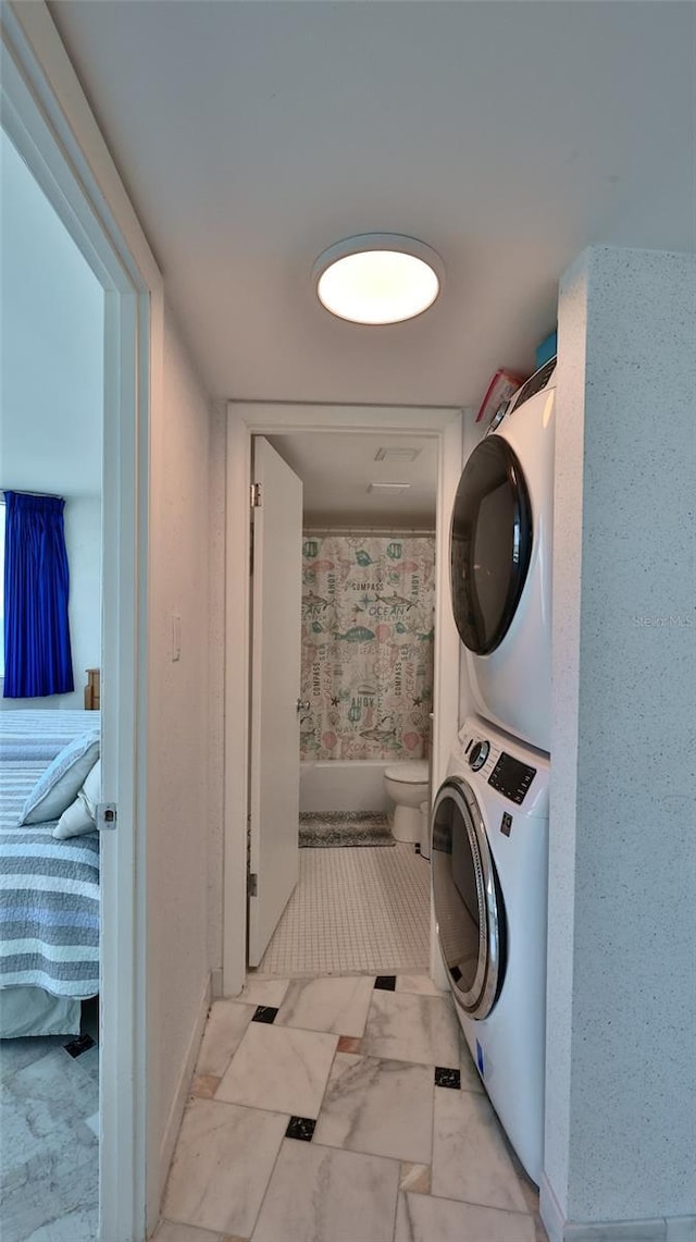 laundry area with stacked washer / drying machine