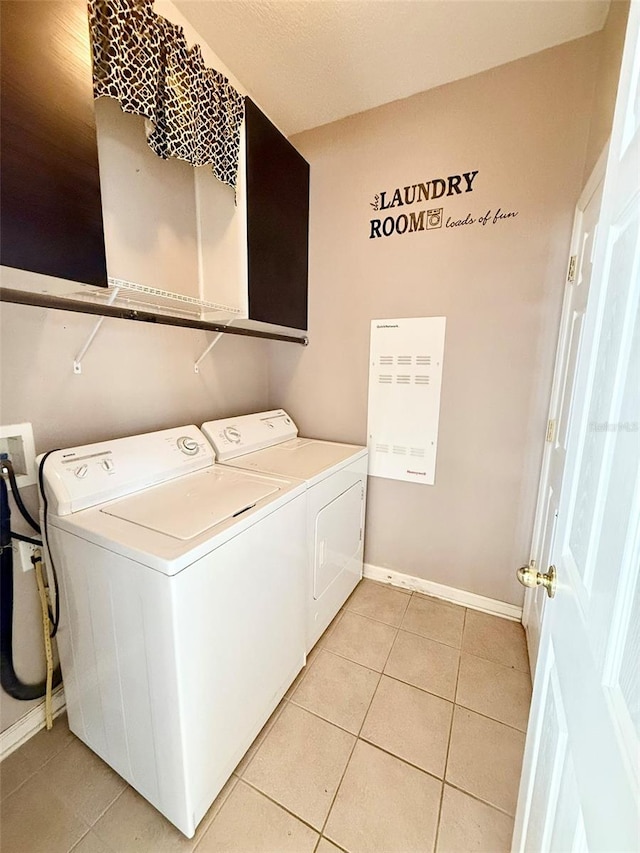 washroom featuring independent washer and dryer and light tile patterned floors