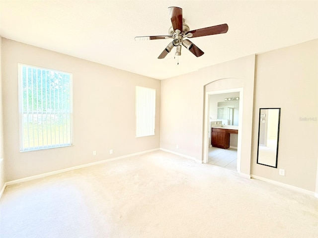 unfurnished room with light colored carpet and ceiling fan