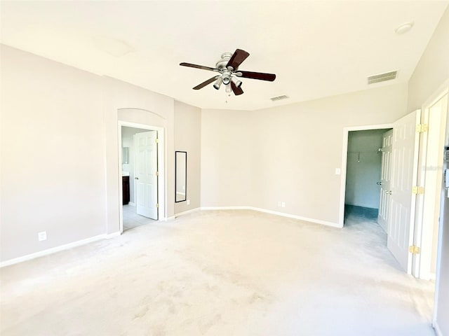 empty room with light colored carpet and ceiling fan