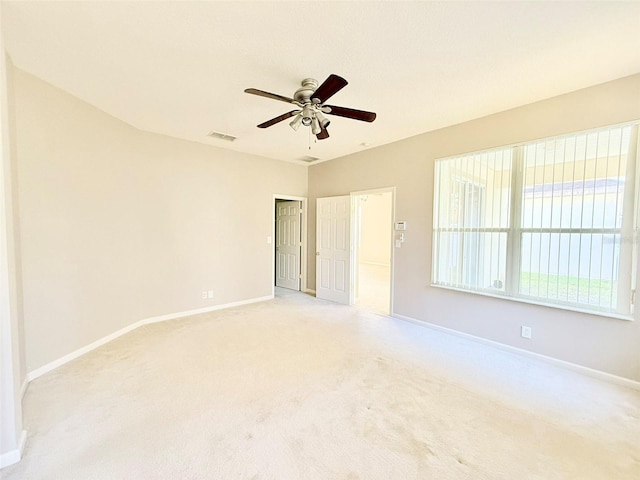 empty room with light carpet and ceiling fan