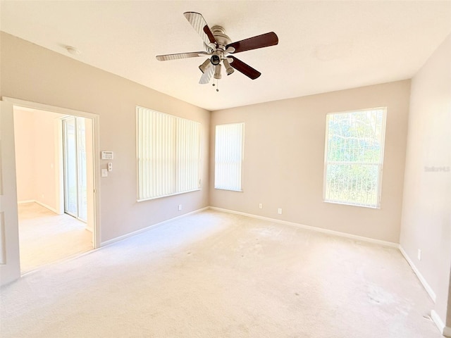 unfurnished room with light carpet and ceiling fan