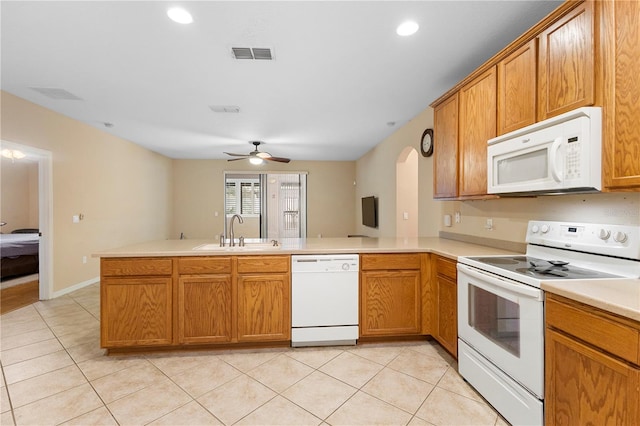 kitchen with white appliances, light tile patterned flooring, sink, kitchen peninsula, and ceiling fan