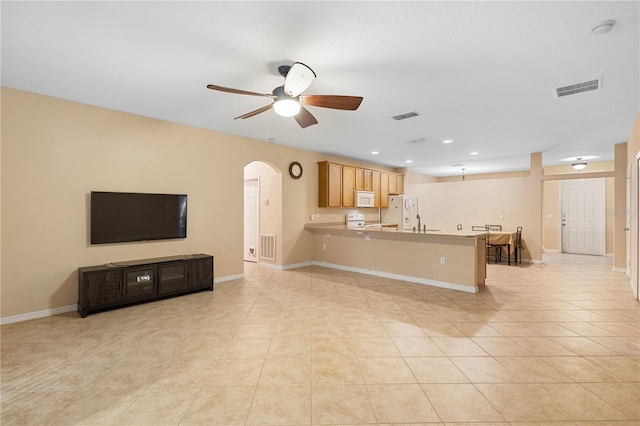 living room with ceiling fan and light tile patterned floors