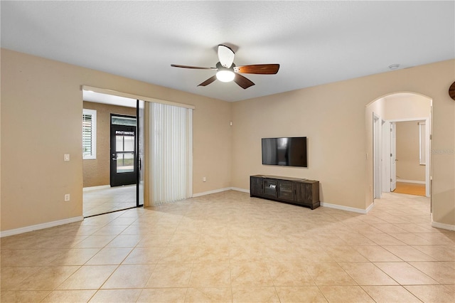 unfurnished living room featuring light tile patterned flooring and ceiling fan