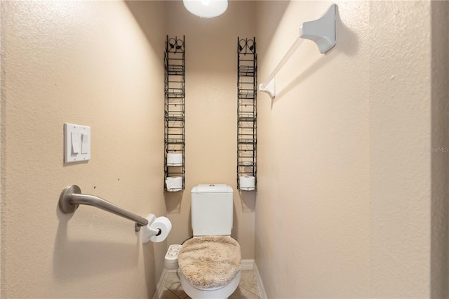 bathroom with toilet and tile patterned flooring