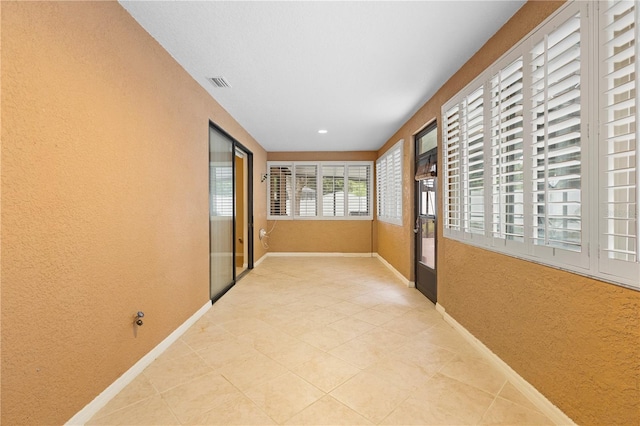 hallway featuring tile patterned flooring