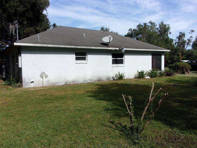 view of side of home with a lawn