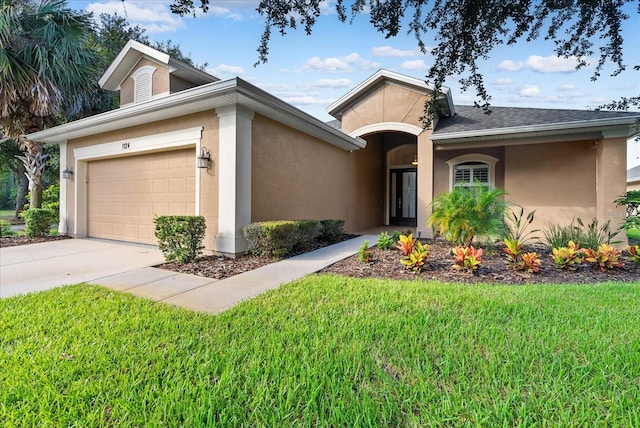 view of front of house featuring a front yard and a garage