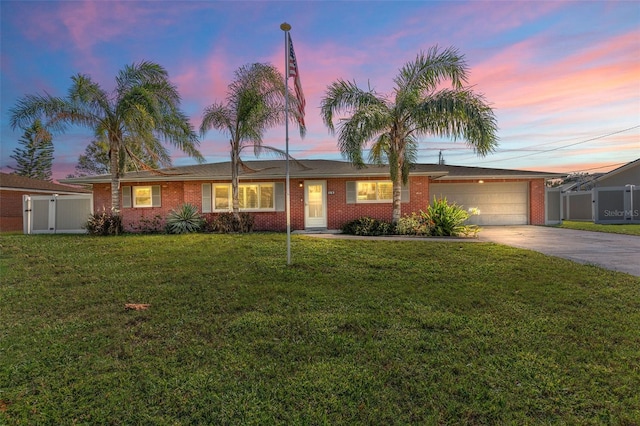 ranch-style house featuring a yard and a garage