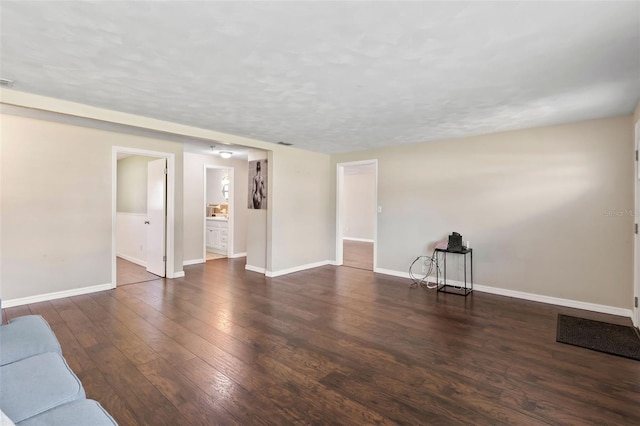 unfurnished living room with dark wood-type flooring