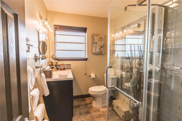 bathroom with vanity, toilet, and a shower with door