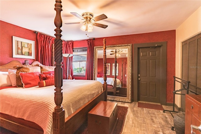 bedroom with light hardwood / wood-style floors and ceiling fan