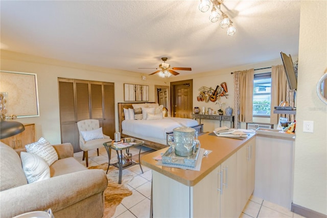 600 Oakridge Blvd, Daytona Beach, FL 32118 - bedroom featuring light tile patterned floors, a textured ceiling, and a ceiling fan