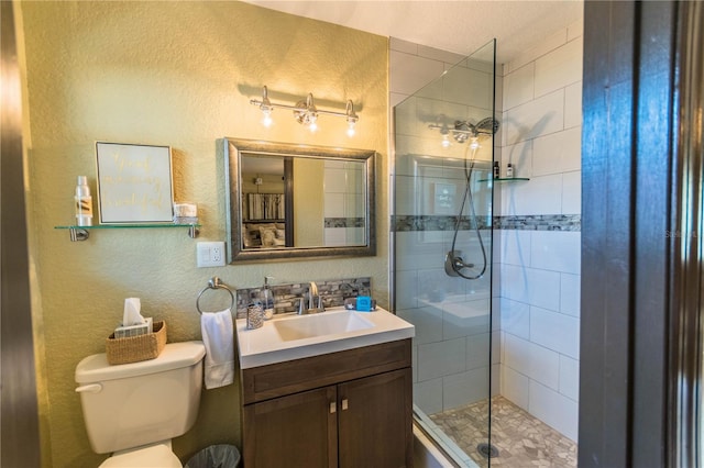 bathroom featuring vanity, toilet, and an enclosed shower