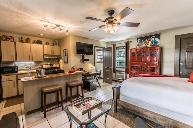 tiled bedroom with ceiling fan, a textured ceiling, sink, and cooling unit